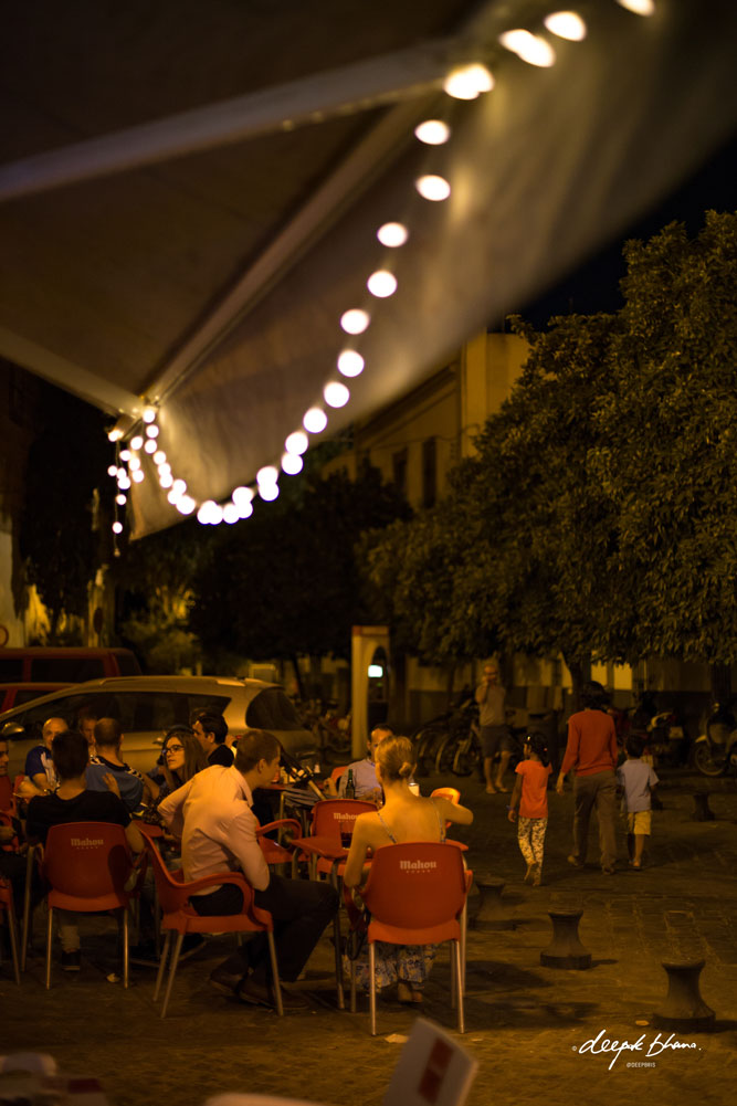 Seville-Spain-family-walking-fairy-light-cafe-night