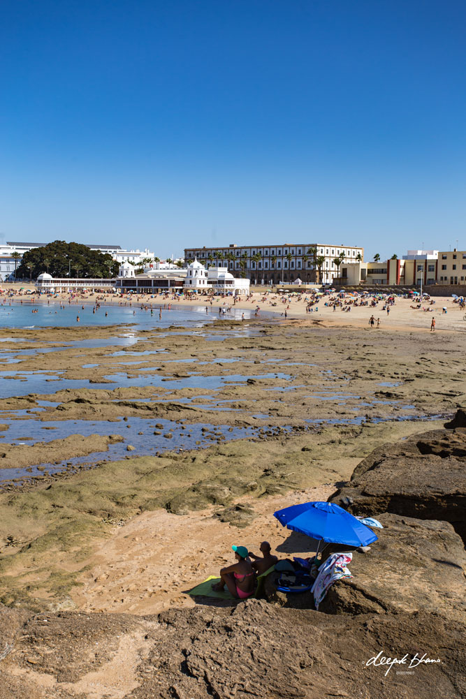 Cadiz-Spain-beach-rocks-umbrella