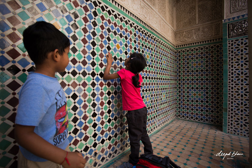 Todayfarer-family-Morocco with kids-Marrakesh-looking-at-mosaic